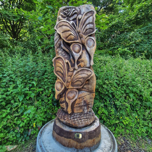 Two wooden butterflies, in woods