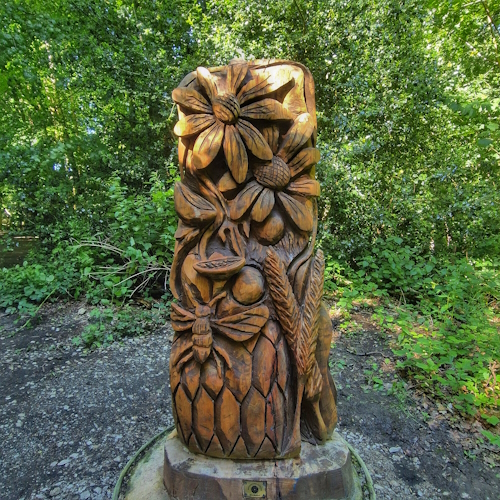 Wooden flowers, insects, and barley, in woods