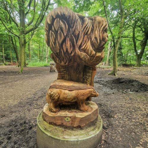 Wooden badger in woods